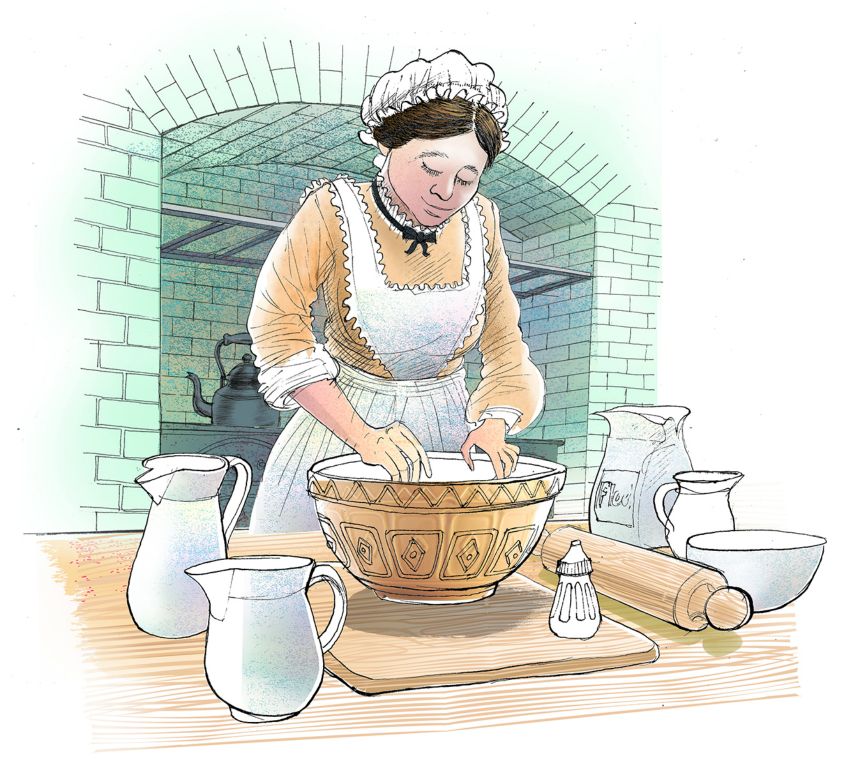 Another maid taking care of the cooking in the large kitchen